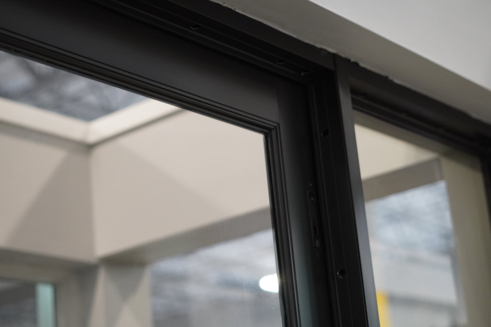 Close-up of a black impact window frame and its weather seal