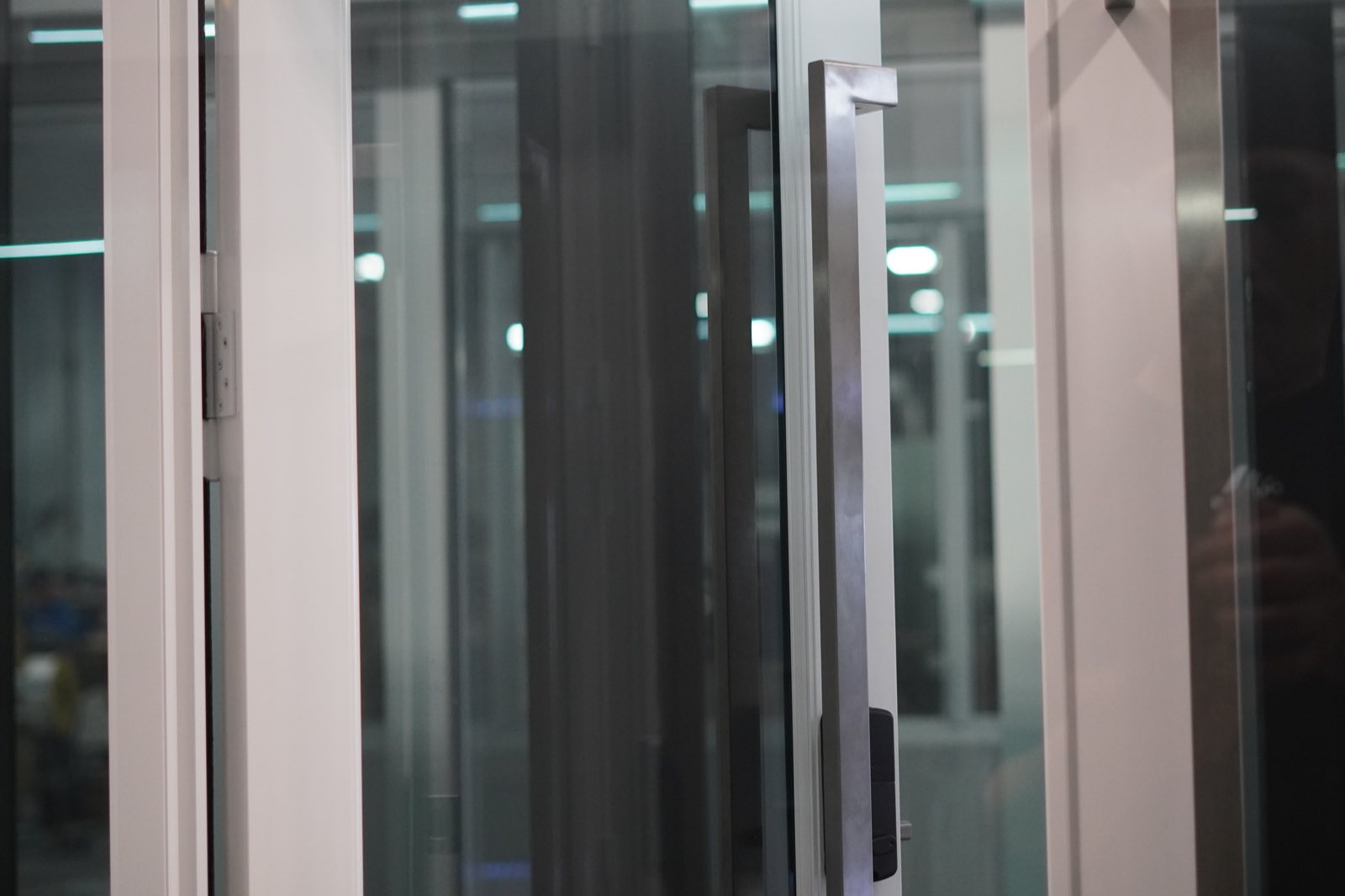 Pull handle and frame detail of a white impact sliding door