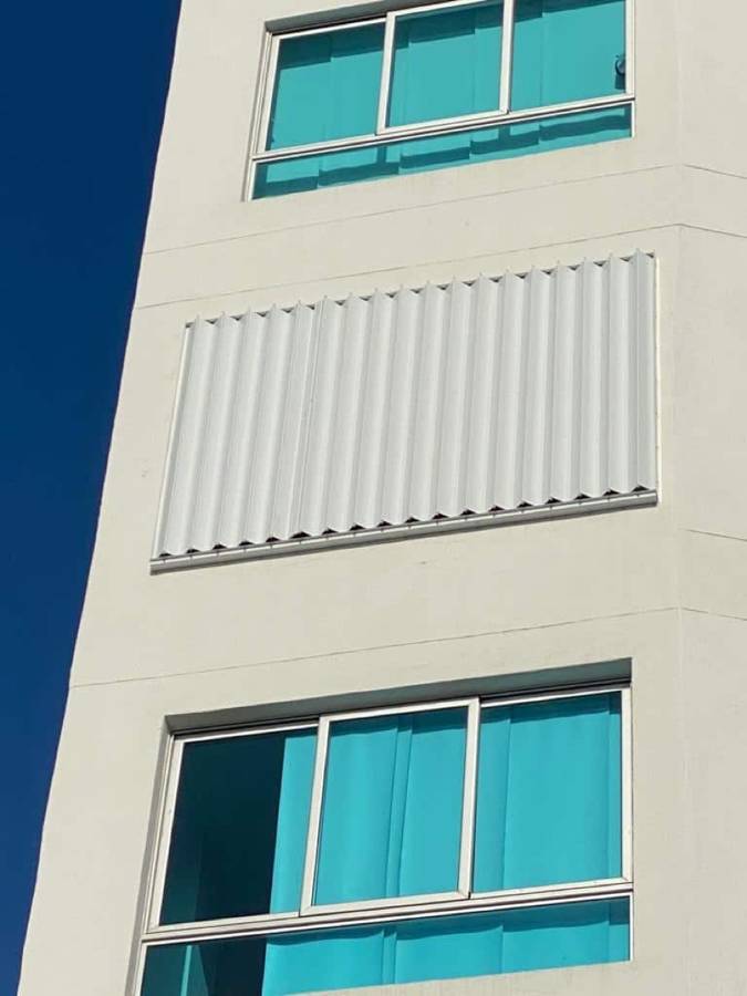 White accordion shutters on a building