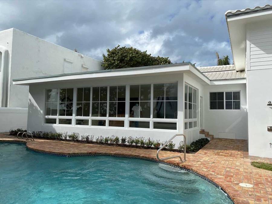 Sunroom with impact windows by the pool